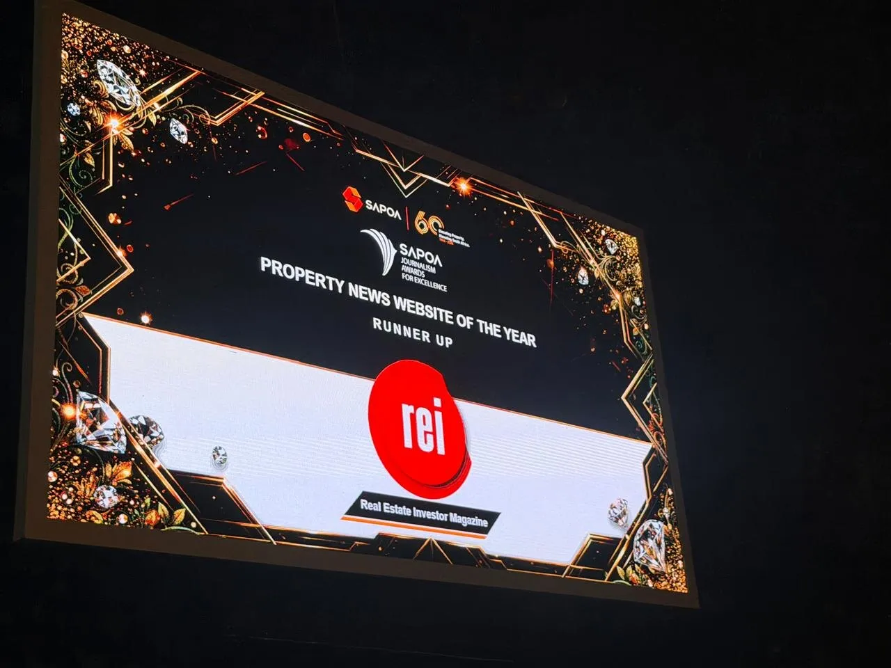 The SAPOA Journalism Awards for Excellence screen at Sun City announcing Real Estate Investor Magazine as runner-up for Property News Website of the Year