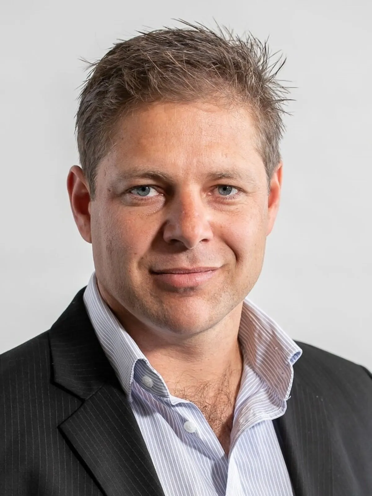 Leon Labuschagne, Head of Development: Logistics and Industrial at Growthpoint Properties, in a dark suit and striped shirt against a light grey background