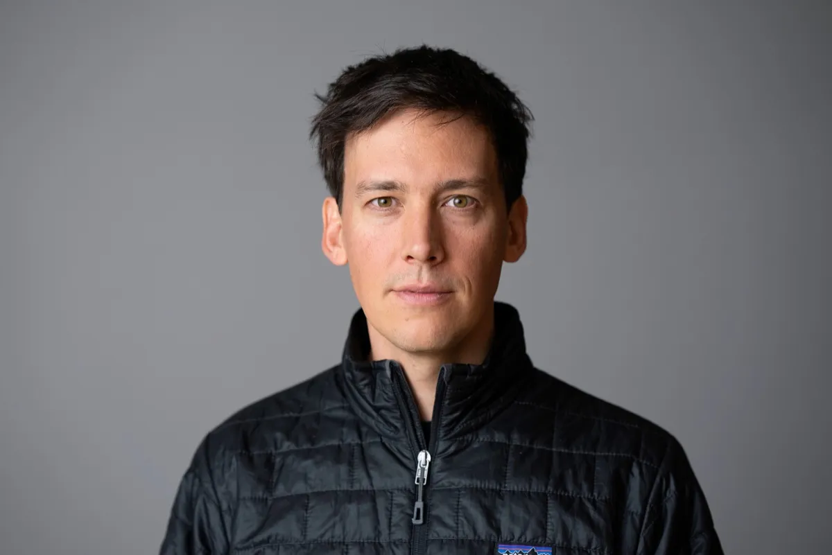 Carel Kleynhans, CEO of Divercity Urban Property Group, in a black quilted jacket against a grey background