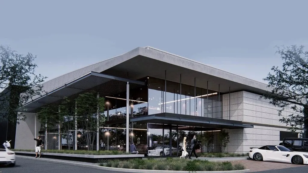 Computer-generated image of a modern two-storey business building with a deep flat roof overhang, full-height glazing and stone-clad walls, with people walking past landscaped beds and white sports cars parked in front at dusk
