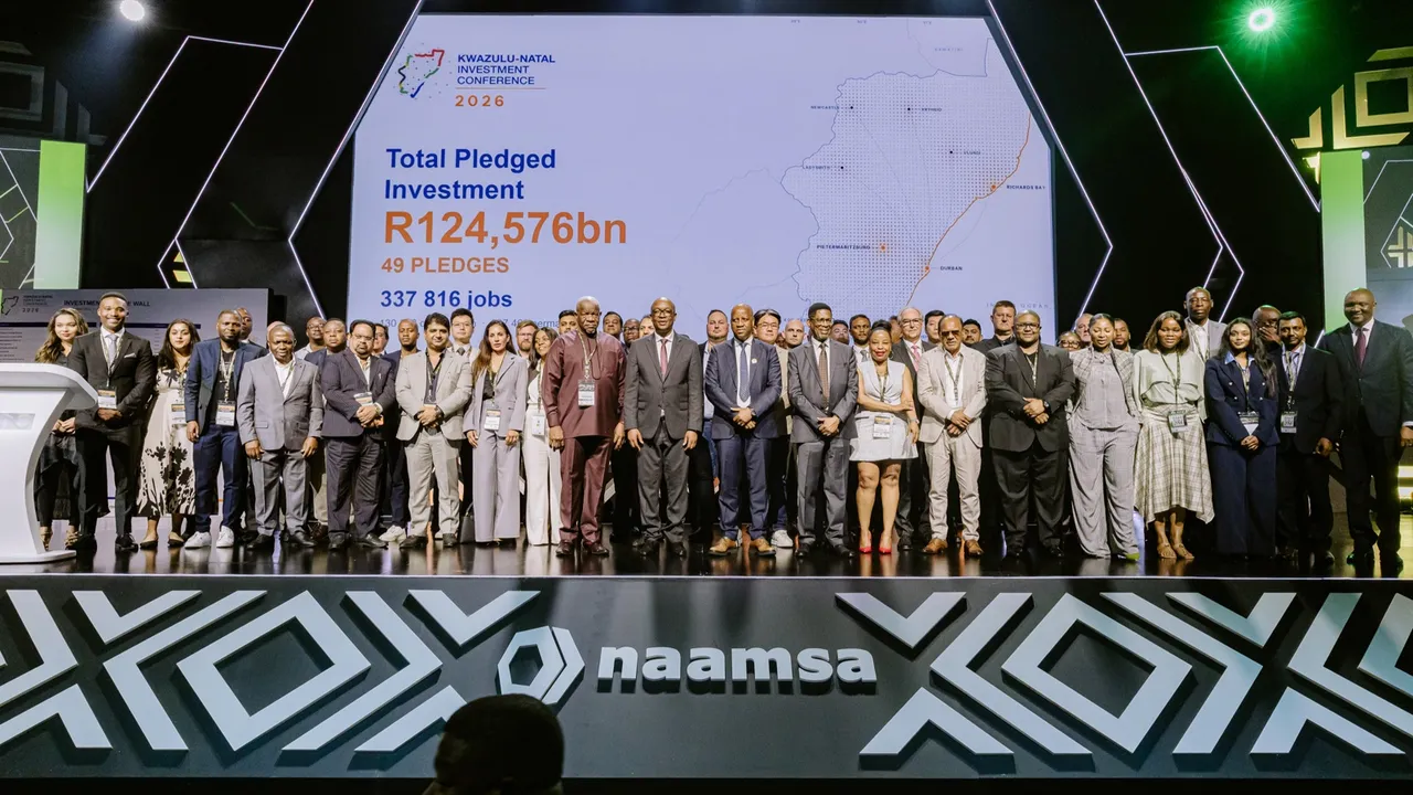 Delegates and pledgers on stage at the 2026 KwaZulu-Natal Investment Conference, in front of a screen showing total pledged investment of R124,576bn, 49 pledges and 337 816 jobs